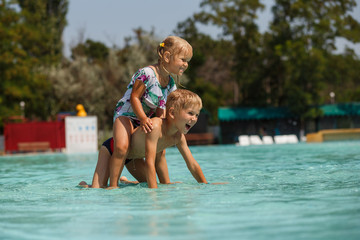 Fototapeta na wymiar children play in the water Park, pool, water, summer, vacation