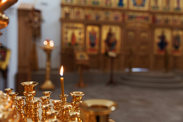Orthodox Church. Christianity. Festive interior decoration with burning candles and icon in traditional Orthodox Church on Easter Eve or Christmas. Religion faith pray symbol.