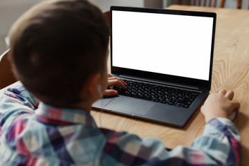 boy child sitting at a laptop, learning remotely, online classes, mock up