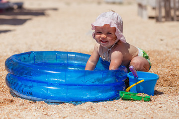 girl playing with water on the beach, happy child