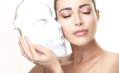 Beauty model woman with led mask. Photon therapy light treatment skin rejuvenation led facial mask