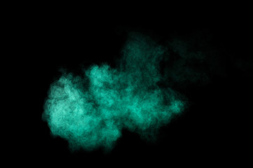 Fototapeta na wymiar Aquamarine powder explosion on black background. Colored powder cloud. Colorful dust explode. Paint Holi.