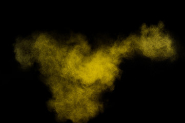 Yellow powder explosion.Yellow powder explosion on black background. Colored powder cloud. Colorful dust explode. Paint  Holi.