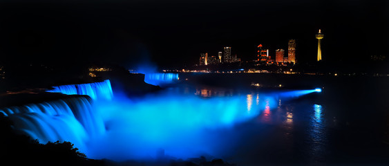 Niagara Falls dark night blue lights view to Canada Panorama. Waterfalls at the border of US state of New York and Canadian province of Ontario. Drains Lake Erie into Lake Ontario.