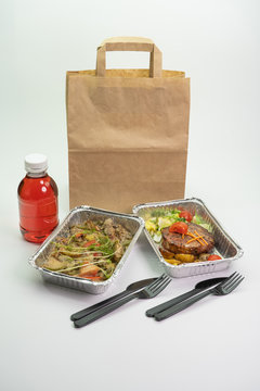 Kraft bag of compote, meat and steak in their foil containers on an isolated white background. The view from the top,