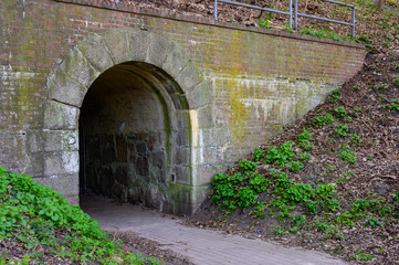 Narrow lane leading to an arched tunnel entrance