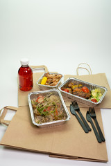 Paper bag foil containers and mors on an isolated background. Contactless food delivery during the quarantine period. © Ekaterina_1525