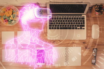 AR hologram drawings over computer on the desktop background. Top view. Multi exposure. Concept of augmented reality.