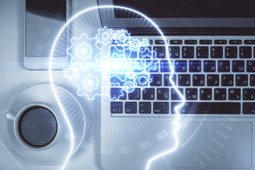 Double exposure of brain drawing hologram over topview work table background with computer. Concept of big data.