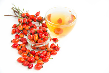 Dog rose, bunch branch Rosehips, types Rosa canina hips and herbal tea - Medicinal plants  herbs composition