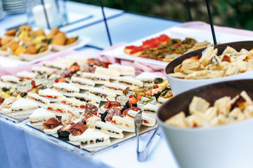 outdoor banquet table with many snacks and delicacies