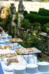 outdoor banquet table with many snacks and delicacies