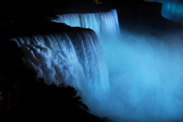 Niagara Falls New York night dark tourists. Waterfalls at the border of US state of New York and Canadian province of Ontario. Drains Lake Erie into Lake Ontario.