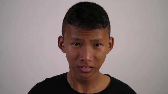 The face of a Asian teenager is a mad man and crazy.