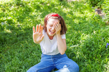 Happy girl smiling outdoor. Beautiful young brunete woman with brown hair resting on park or garden...