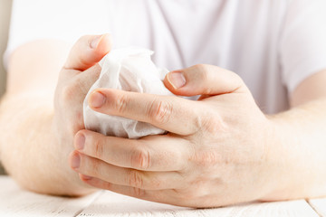 Close up on midsection of man hands wiping using white alcohol tissue cleaning napkin disinfection from virus and bacteria in day at home or office