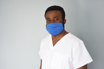 Doctor in mask. Black man african american doctor portrait wearing safety mask at work. Medical staff. Coronavirus.