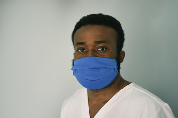 Doctor in mask. Black man african american doctor portrait wearing safety mask at work. Medical staff. Coronavirus.