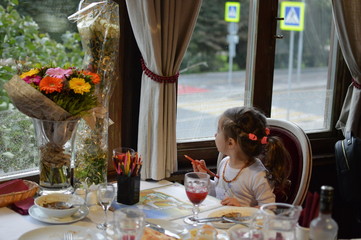 little lady draws in a restaurant.