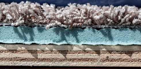 Carpet, padding, and plywood layers for installation of flooring © Lost_in_the_Midwest