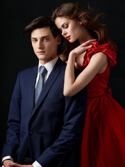 Man and woman studio portrait charm romance dark background