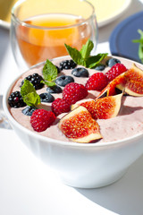 Smoothie bowl morning breakfast on the white bright sunny background. Close up