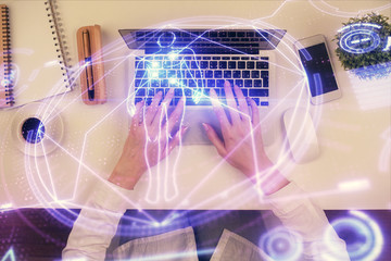 Double exposure of woman hands working on computer and education theme hologram drawing. Top View. Science concept.