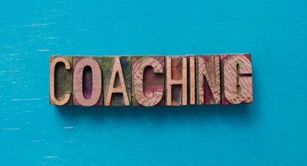 Coaching word written with wood type blocks