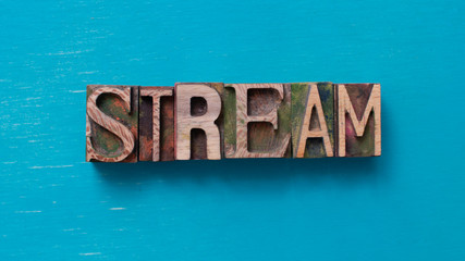 Stream  word written with wood type blocks
