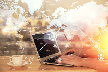Double exposure of woman hands typing on computer and social network theme hologram drawing. People media concept.