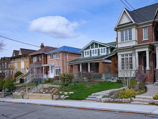Residential street with a variety of older and newer houses and a mix of detached and semi-detached