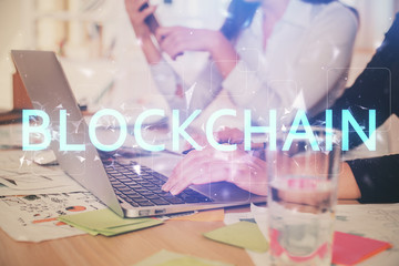 Double exposure of woman hands typing on computer and crypto market theme hologram drawing. Blockchain concept.