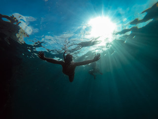 Underwater photo of men snorkeling in a sea
