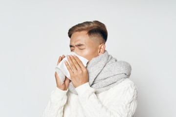 A man of Asian appearance has a common cold. Handkerchief