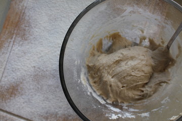 Rye Buckwheat dough rising in a bowl with a flour board dusted and used for baking