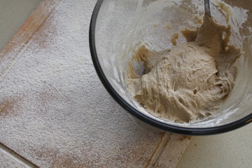 Rye Buckwheat dough rising in a bowl with a flour board dusted and used for baking