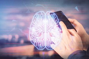Double exposure of man's hand holding and using a digital device and brain hologram drawing. Data...