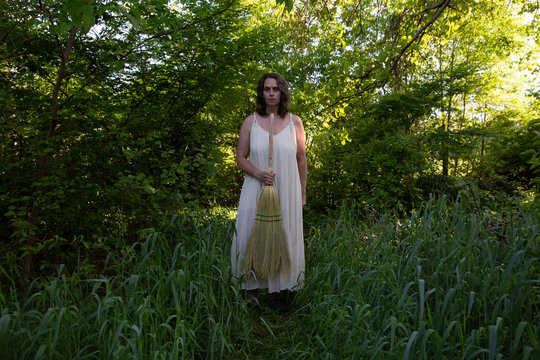 Woman in white dress with handmade broom 9