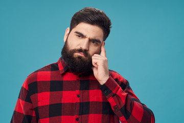 Fototapeta premium Bearded man plaid shirt pensive look studio blue background
