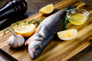 raw fish on a cutting board for grill