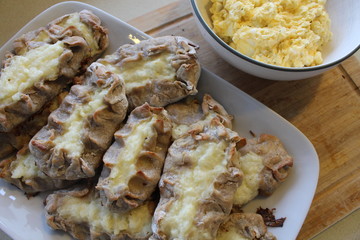 Cooked Karelian pies - Pirakka on a baking sheet. Dish of national cuisine - piirakka. Close-up.
