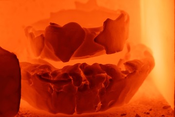 Glowing pottery during the burning process in a kiln.