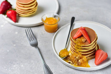 pancake with orange jam, nuts and fresh strawberries. Breakfast food in the morning. pancake recipe. selective focus and copy space. home cooking recipe