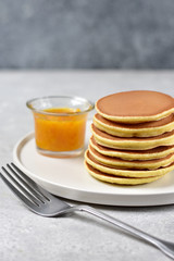 pancakes with lemon jam on a white craft plate. family Breakfast dish, food for children in the morning.  pancake recipe. food delivery gluten free pancakes