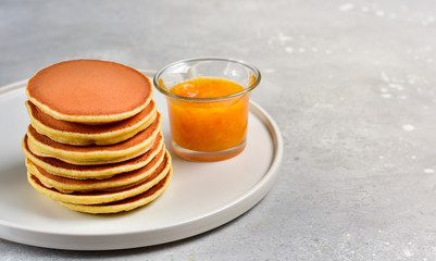 pancakes with lemon jam on a white craft plate. family Breakfast dish, food for children in the morning.  pancake recipe. food delivery gluten free pancakes