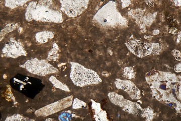 Microscopic photo of a petrographic thin section of roman concrete, opus caementicium, in polarized...