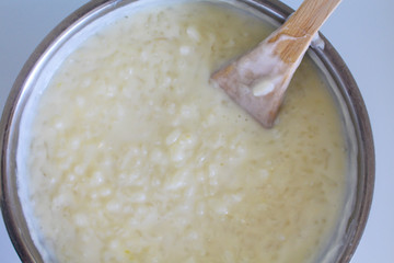 Cooking of rice porridge on oven, the first stage of preparation of national Finnish dish from rye flour and rice - Karelian pies
