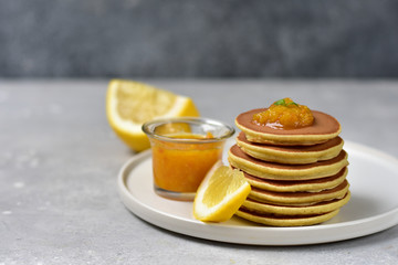 pancakes with lemon jam on a white craft plate. family Breakfast dish, food for children in the morning.  pancake recipe. food delivery gluten free pancakes