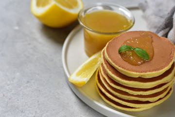 pancakes with lemon jam on a white craft plate. family Breakfast dish, food for children in the...