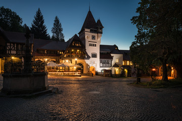 SINAIA, ROMANIA - AUGUST 2019: Vila Economat and La Tunuri, a beautiful hotel, restaurant and cafe at dawn, in the Peles Castle park